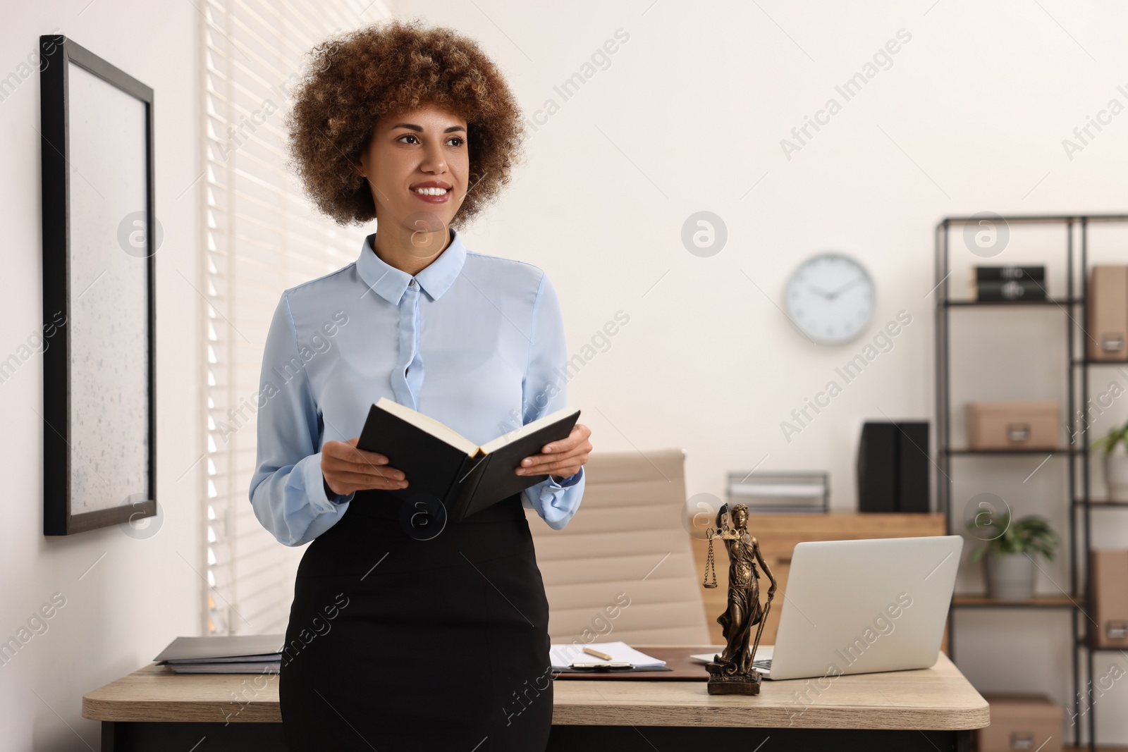 Photo of Portrait of happy notary with notebook in office