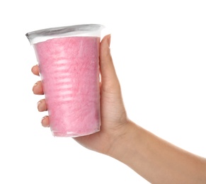 Woman holding plastic cup with yummy cotton candy on white background, closeup