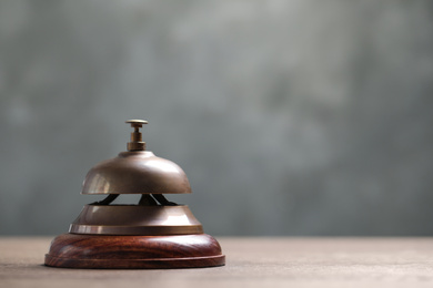 Photo of Hotel service bell on table, closeup. Space for text