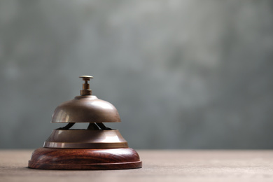 Hotel service bell on table, closeup. Space for text