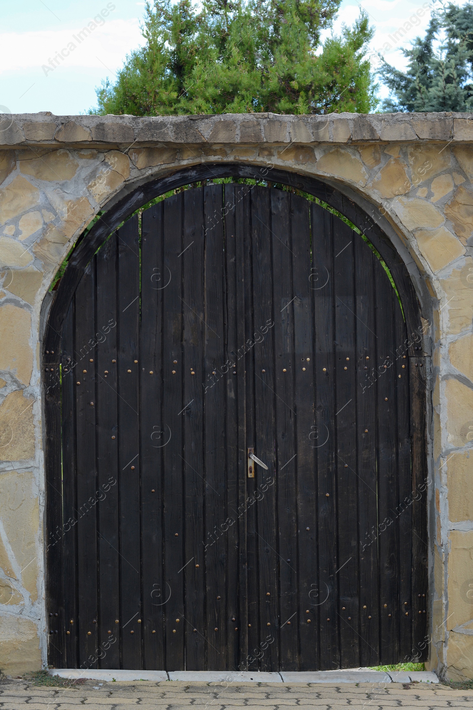 Photo of Entrance of building with beautiful arched wooden door outdoors