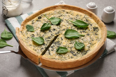 Photo of Fresh delicious homemade spinach pie on grey table