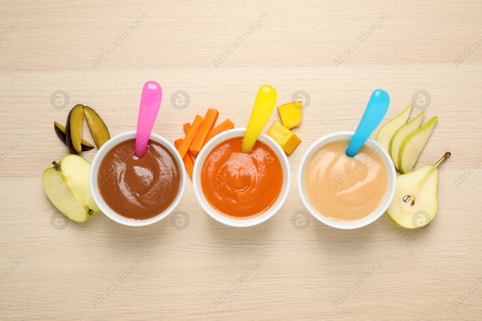 Photo of Healthy baby food and ingredients on wooden table, flat lay