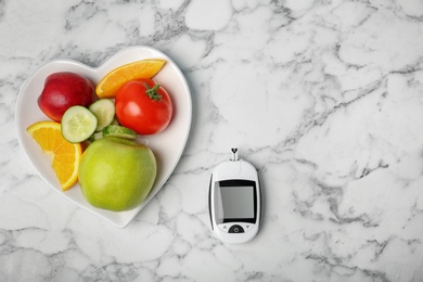 Photo of Flat lay composition with digital glucometer, fruits and vegetables on table. Diabetes concept