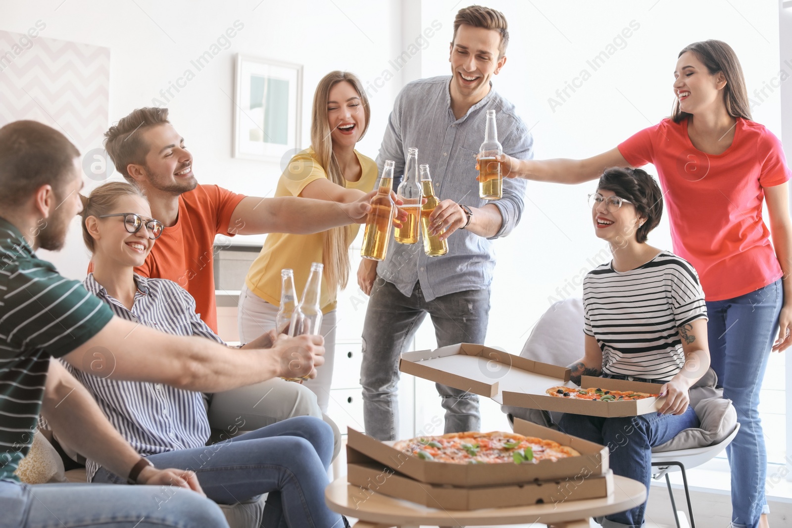 Photo of Young people having fun party with delicious pizza indoors