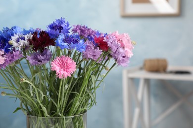 Photo of Bouquet of beautiful cornflowers in vase at home, closeup