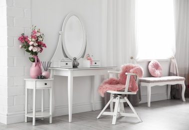 Stylish room interior with white dressing table