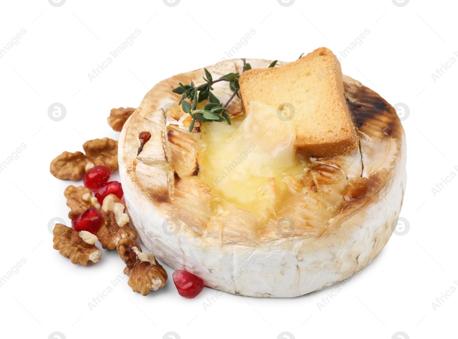 Photo of Tasty baked camembert with crouton, thyme, walnuts and pomegranate seeds isolated on white