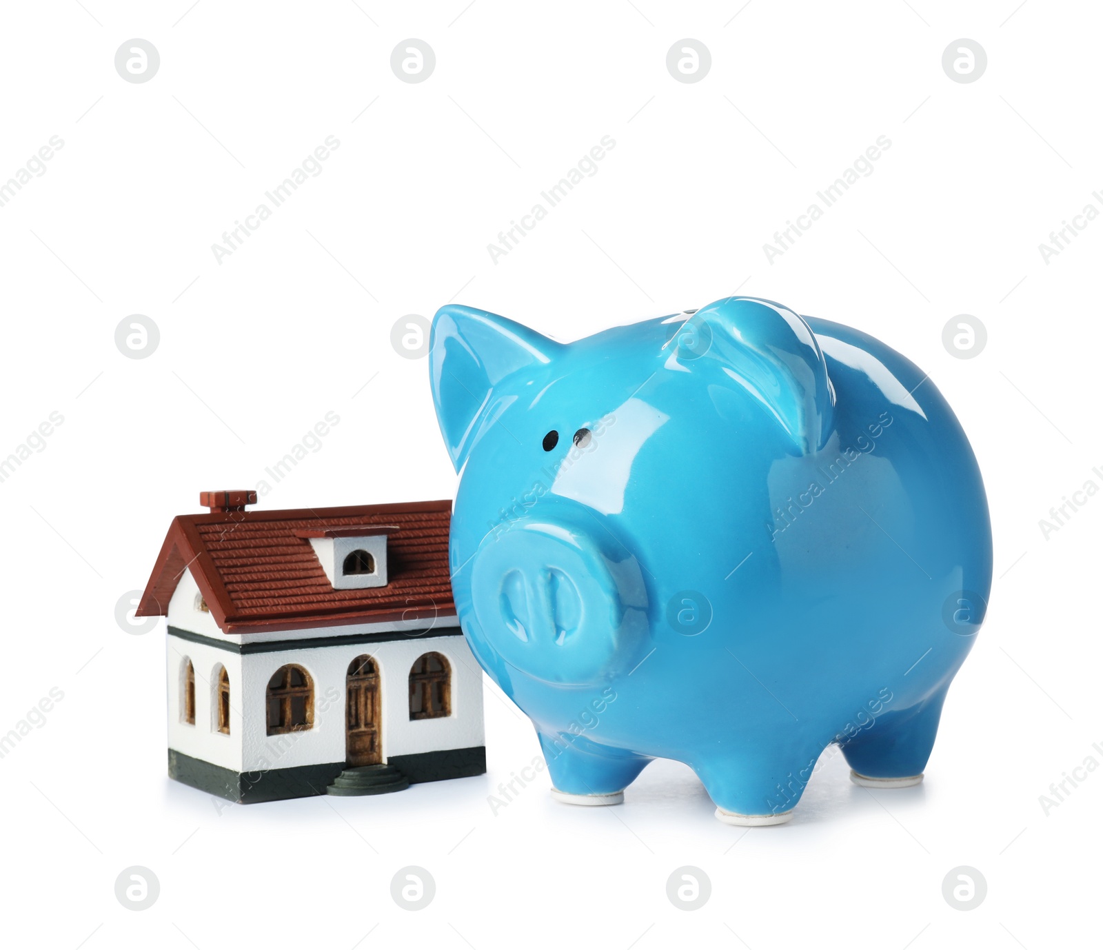 Photo of Piggy bank with house model isolated on white