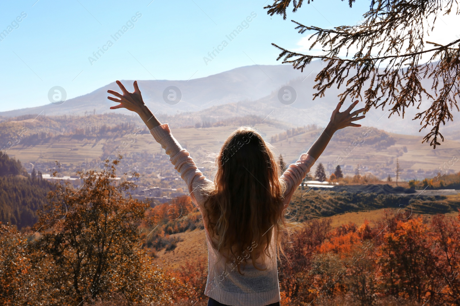 Photo of Female traveler feeling free in peaceful mountains