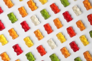 Delicious color jelly bears on white background, top view