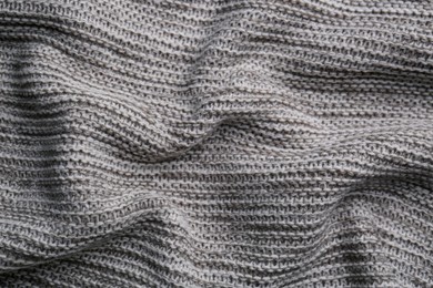 Beautiful grey knitted fabric as background, top view