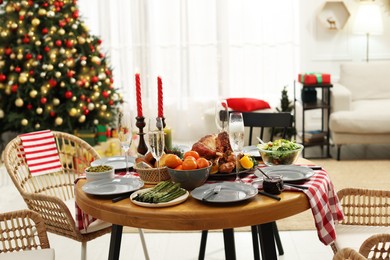 Photo of Festive dinner with delicious food and wine on table indoors. Christmas celebration