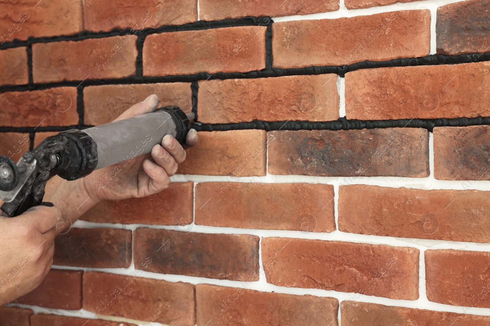 Photo of Professional builder using tiling fugue for grouting, closeup