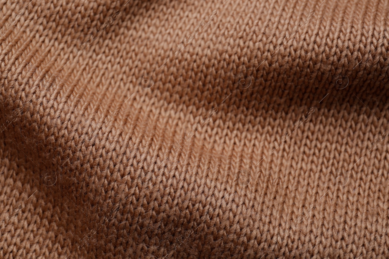 Photo of Brown knitted fabric as background, closeup view