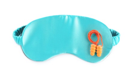 Pair of ear plugs and light blue sleeping mask on white background, top view