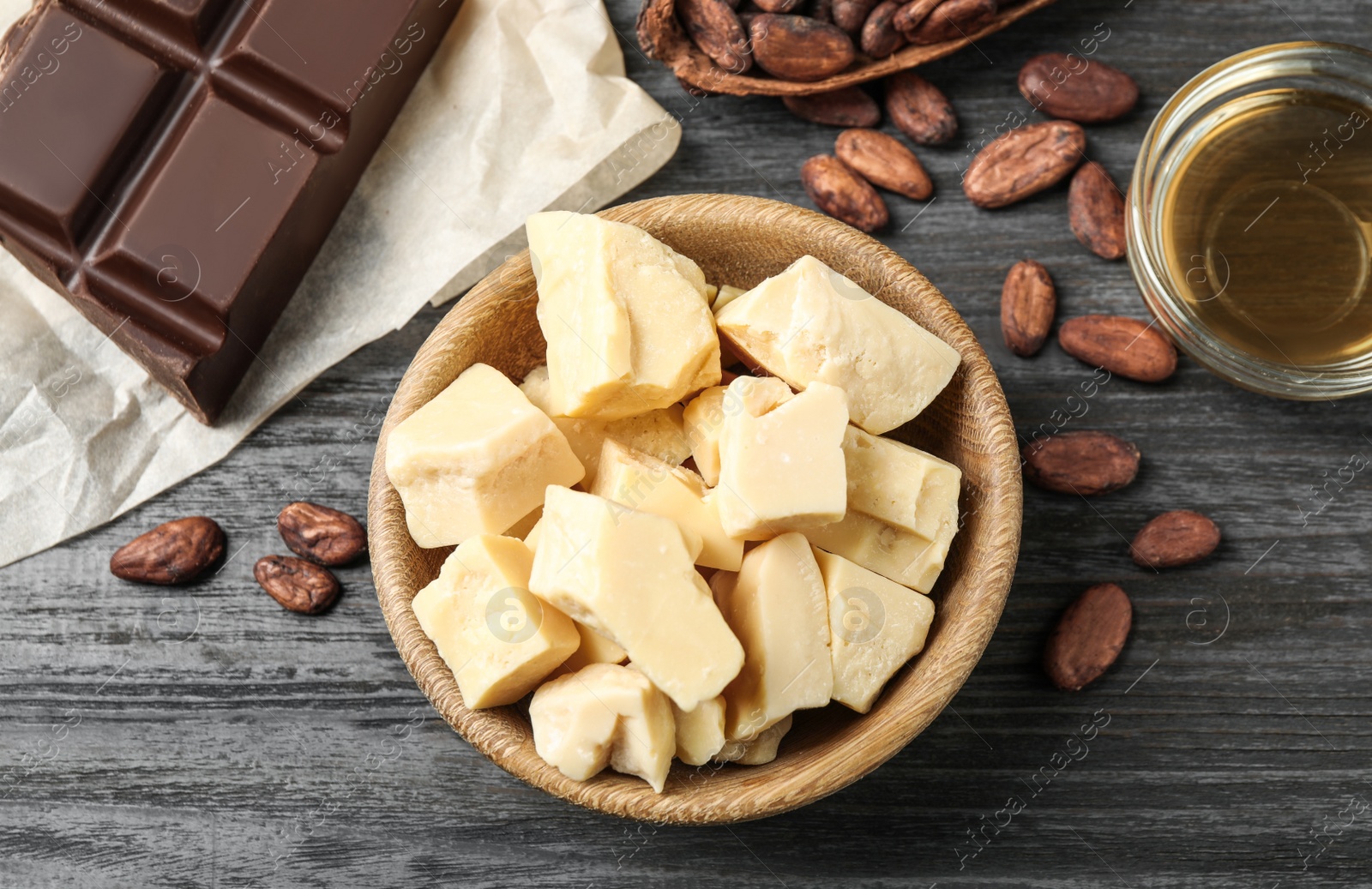 Photo of Flat lay composition with organic cocoa butter on black wooden table