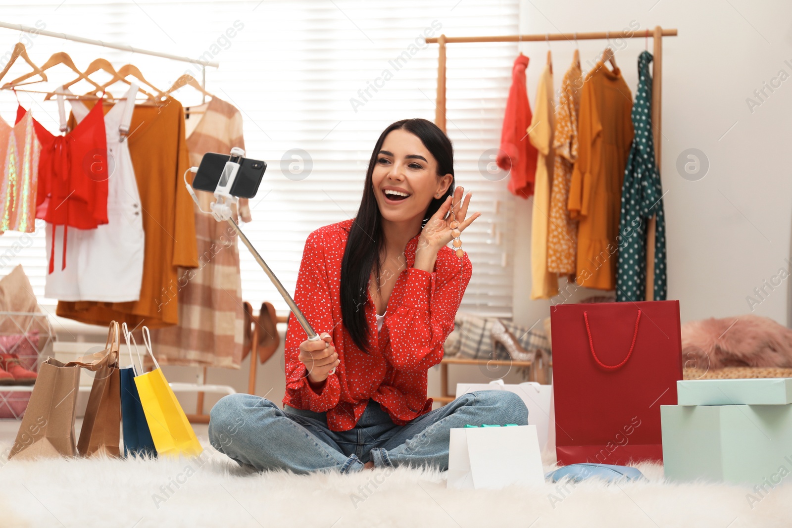 Photo of Fashion blogger recording new video with smartphone in room