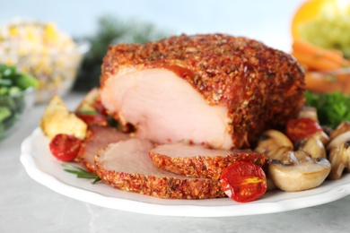 Plate with homemade delicious ham on grey table, closeup. Festive dinner