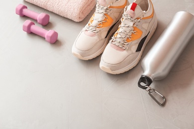 Photo of Composition with fitness equipment on gray background. Space for text