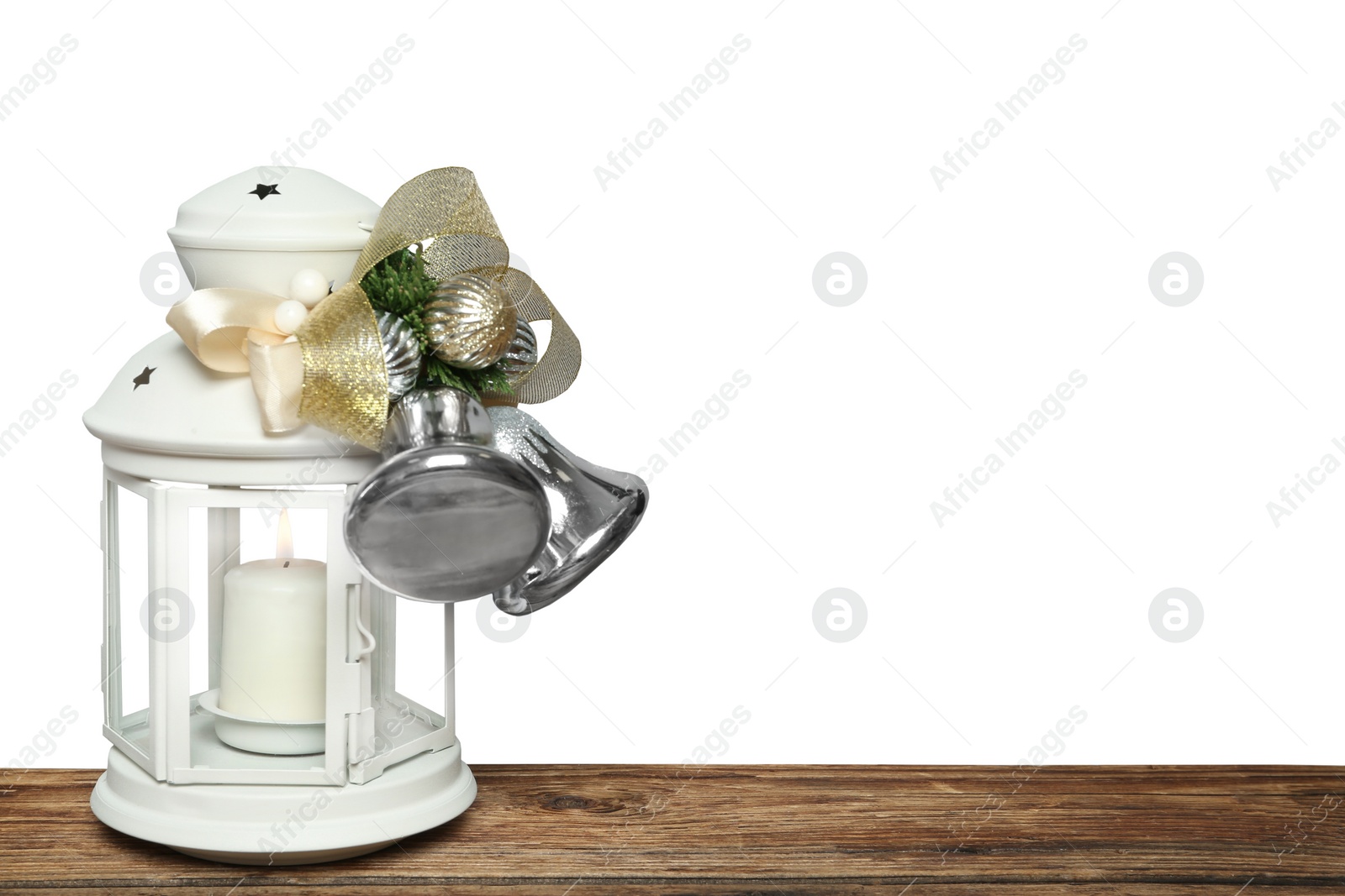 Photo of Decorated Christmas lantern with burning candle on wooden table, space for text