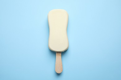 Ice cream with glaze on light blue background, top view