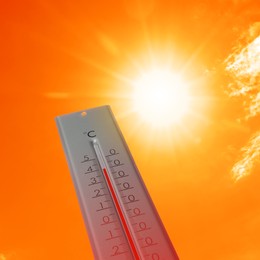 Weather thermometer with high temperature outdoors on hot sunny day. Heat stroke warning