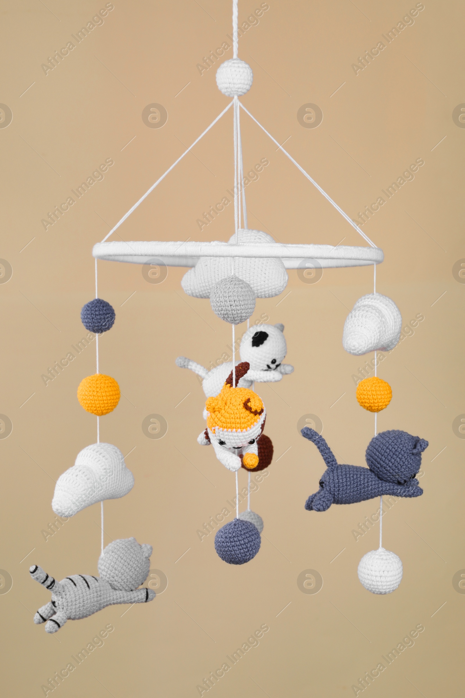 Photo of Cute baby crib mobile on beige background