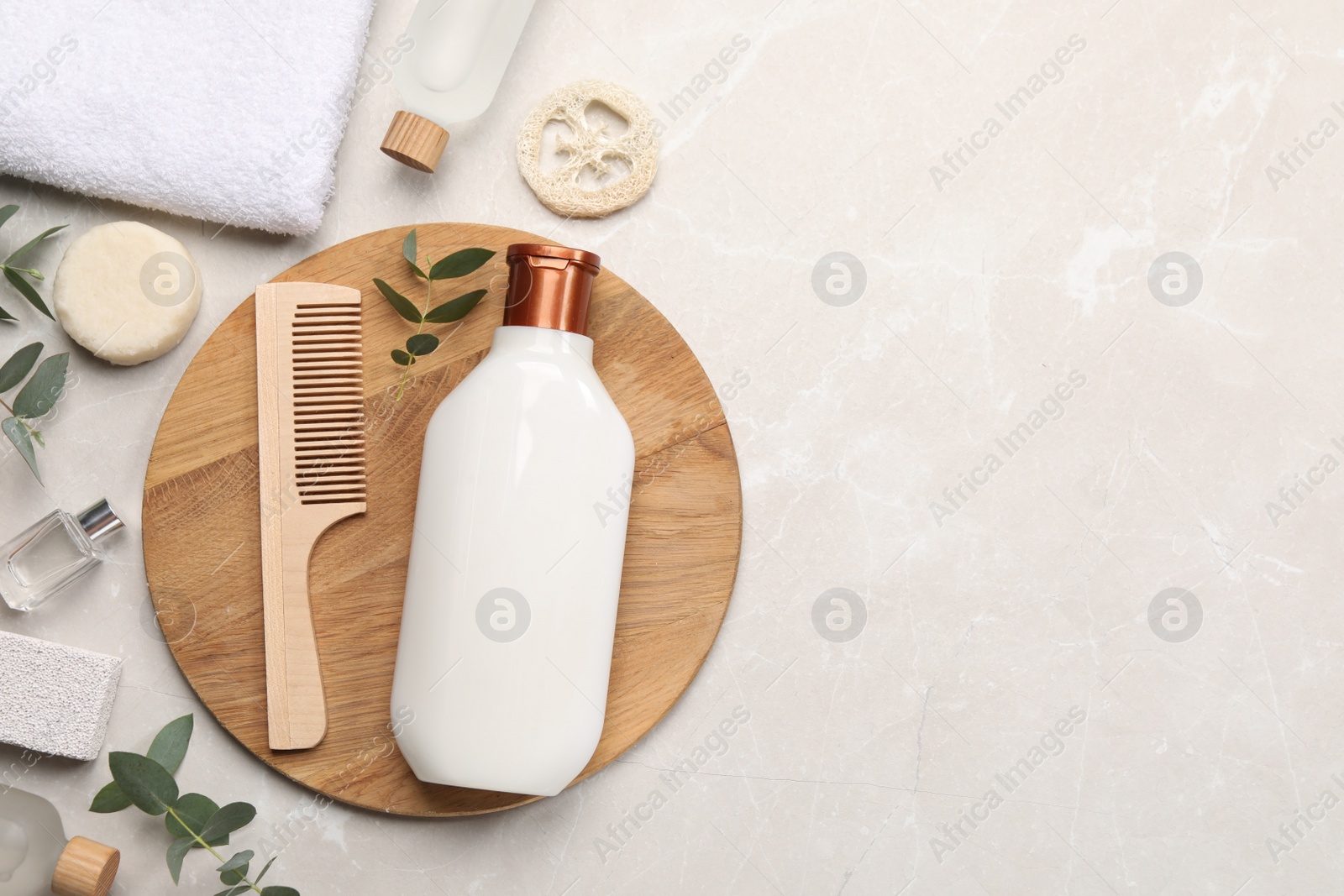 Photo of Flat lay composition with solid shampoo bar and bottle of cosmetic product on light grey table, space for text
