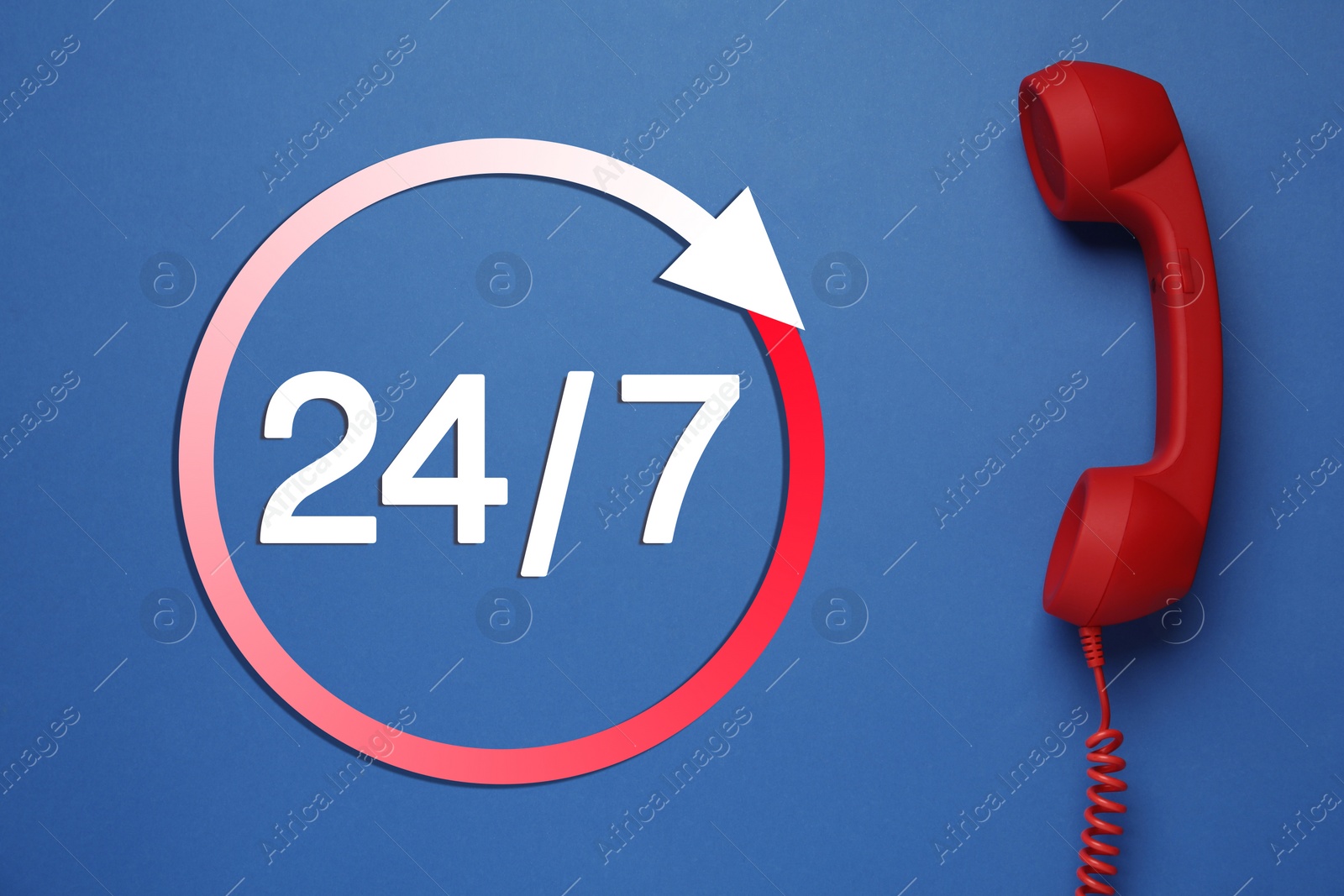 Image of 24/7 hotline service. Red handset on blue background, top view