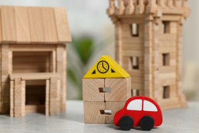 Photo of Set of wooden toys on light grey table indoors, closeup. Children's development