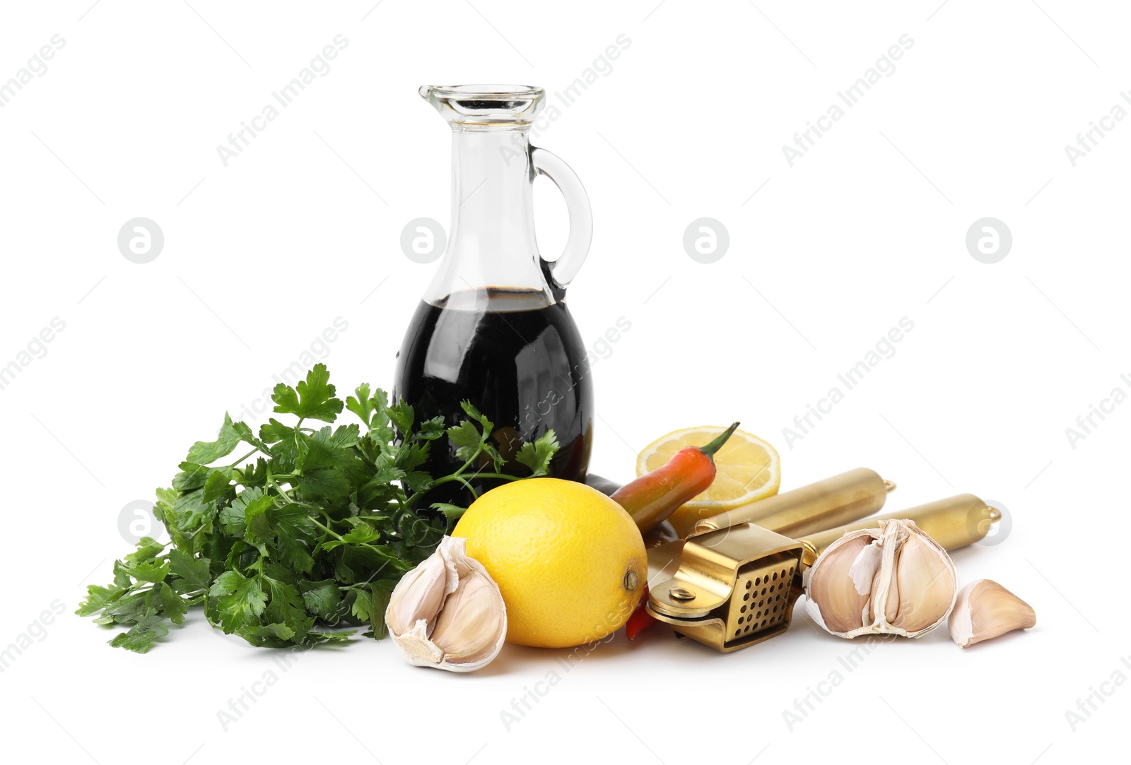 Photo of Different fresh ingredients for marinade and garlic press on white background