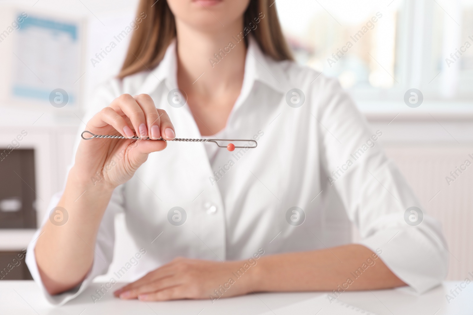 Photo of Speech therapist with logopedic probe in clinic, closeup