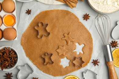 Photo of Flat lay composition with dough and cookie cutters on light table