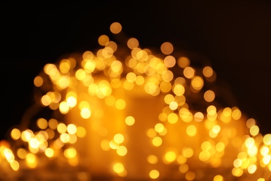 Photo of Gold glitter with bokeh effect on dark background