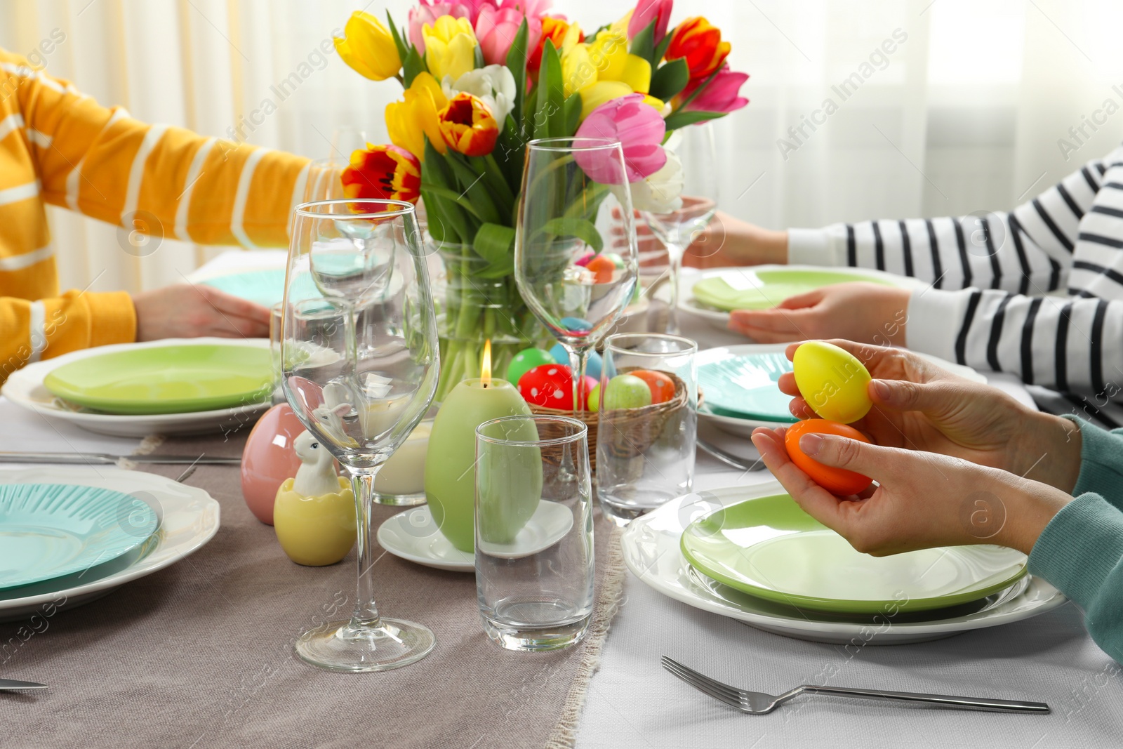 Photo of Festive table setting. Women celebrating Easter at home, closeup