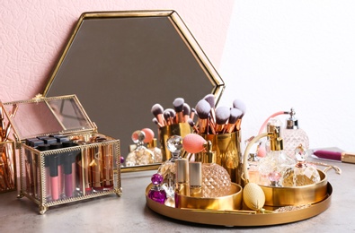 Photo of Set of luxury makeup products and perfumes on dressing table