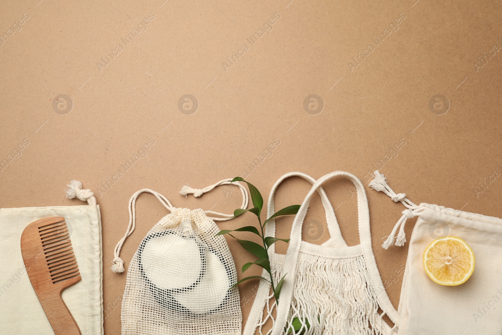 Photo of Eco friendly products on brown background, flat lay. Space for text