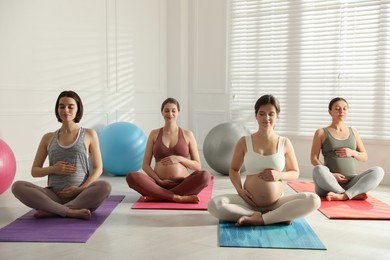 Photo of Group of pregnant women practicing yoga in gym