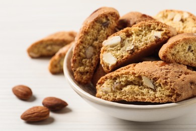 Photo of Traditional Italian almond biscuits (Cantucci) on white wooden table, closeup