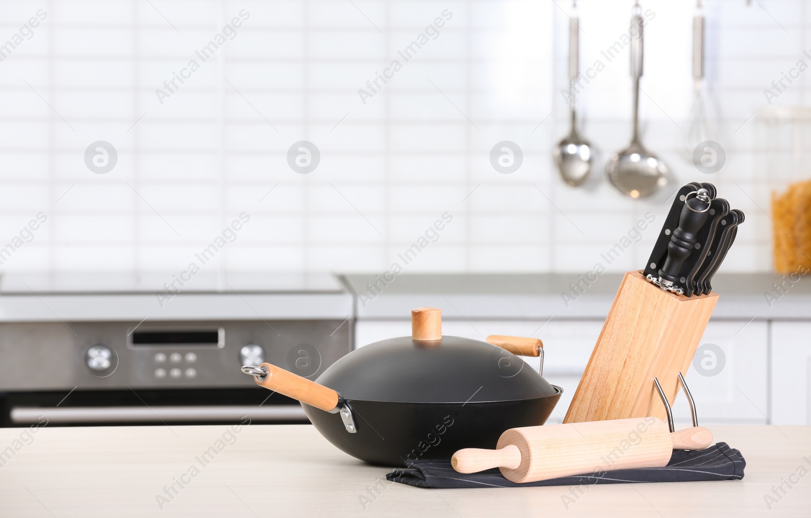 Photo of Set of clean cookware and utensils on table in kitchen. Space for text