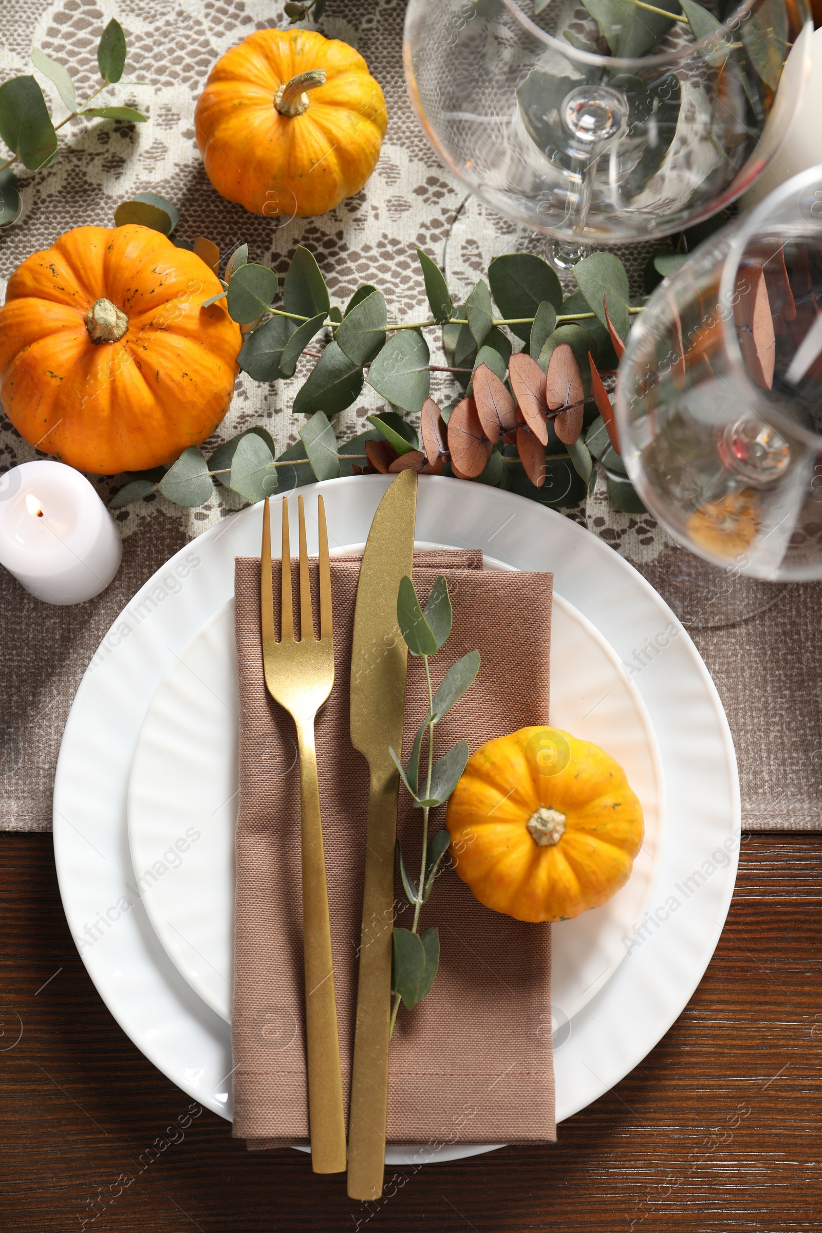 Photo of Autumn table setting, pumpkins and eucalyptus branches, flat lay