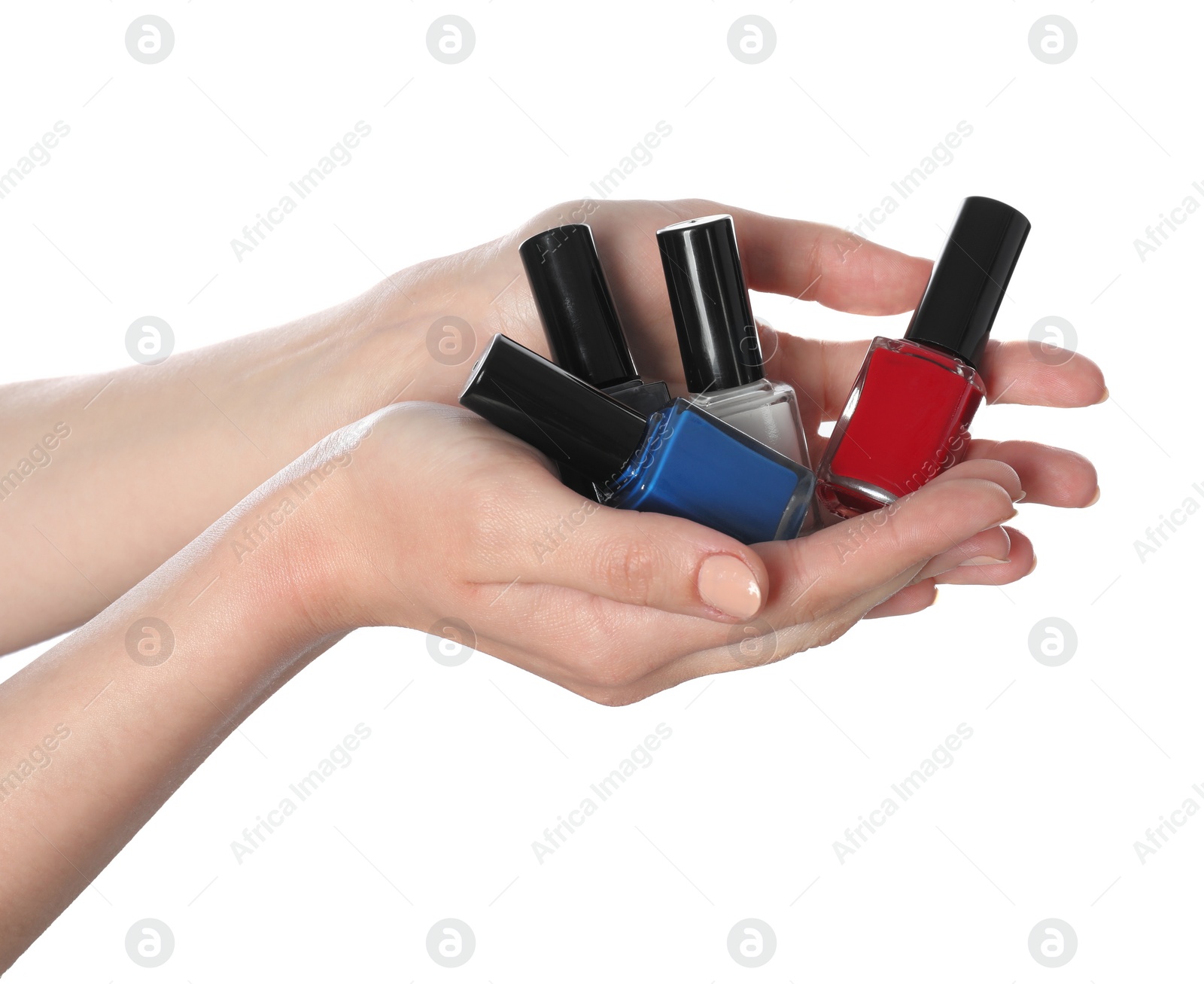 Photo of Woman holding nail polishes on white background, closeup