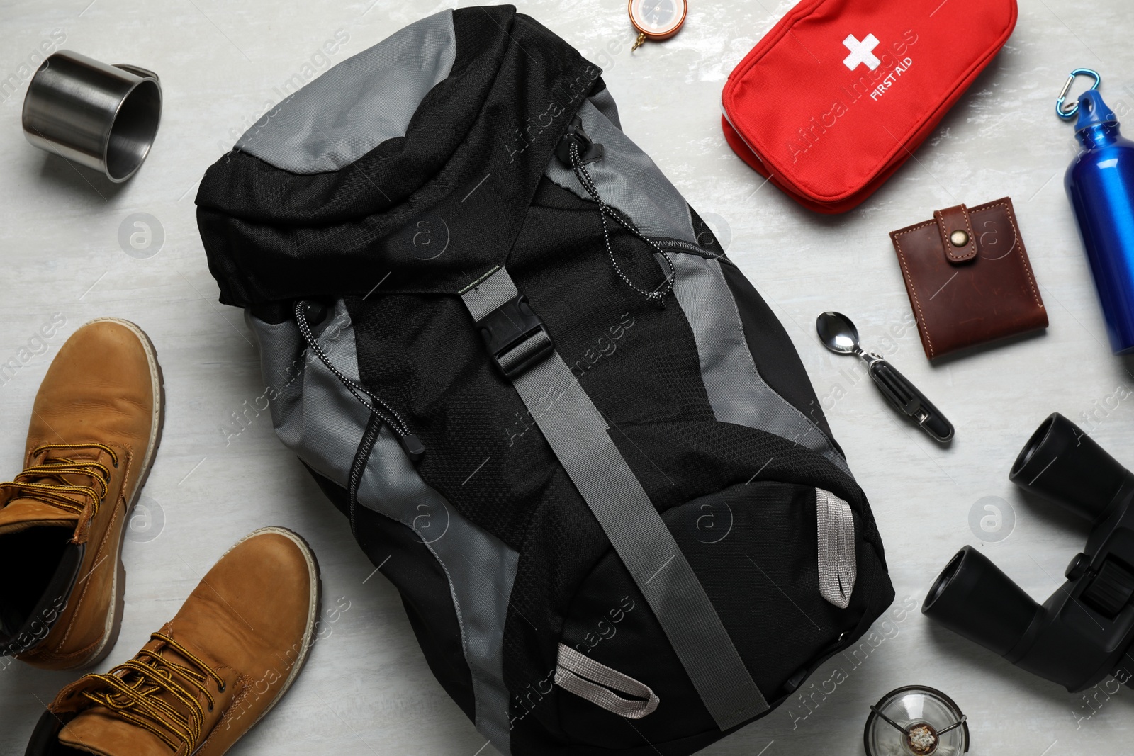 Flat lay composition with different camping equipment on light background Photo of Flat lay composition with different camping equipment on light background