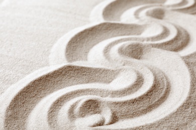 Photo of Zen garden pattern on sand. Meditation and harmony