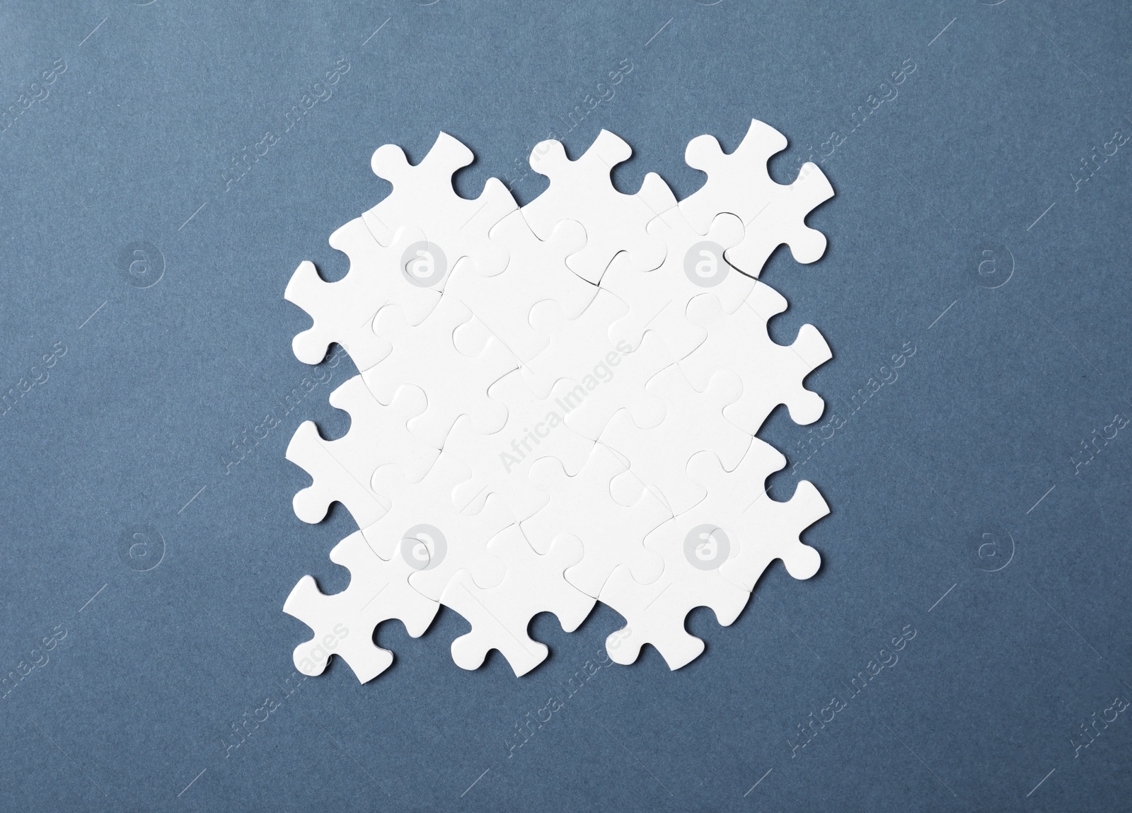 Photo of Blank white puzzle pieces on grey background, top view