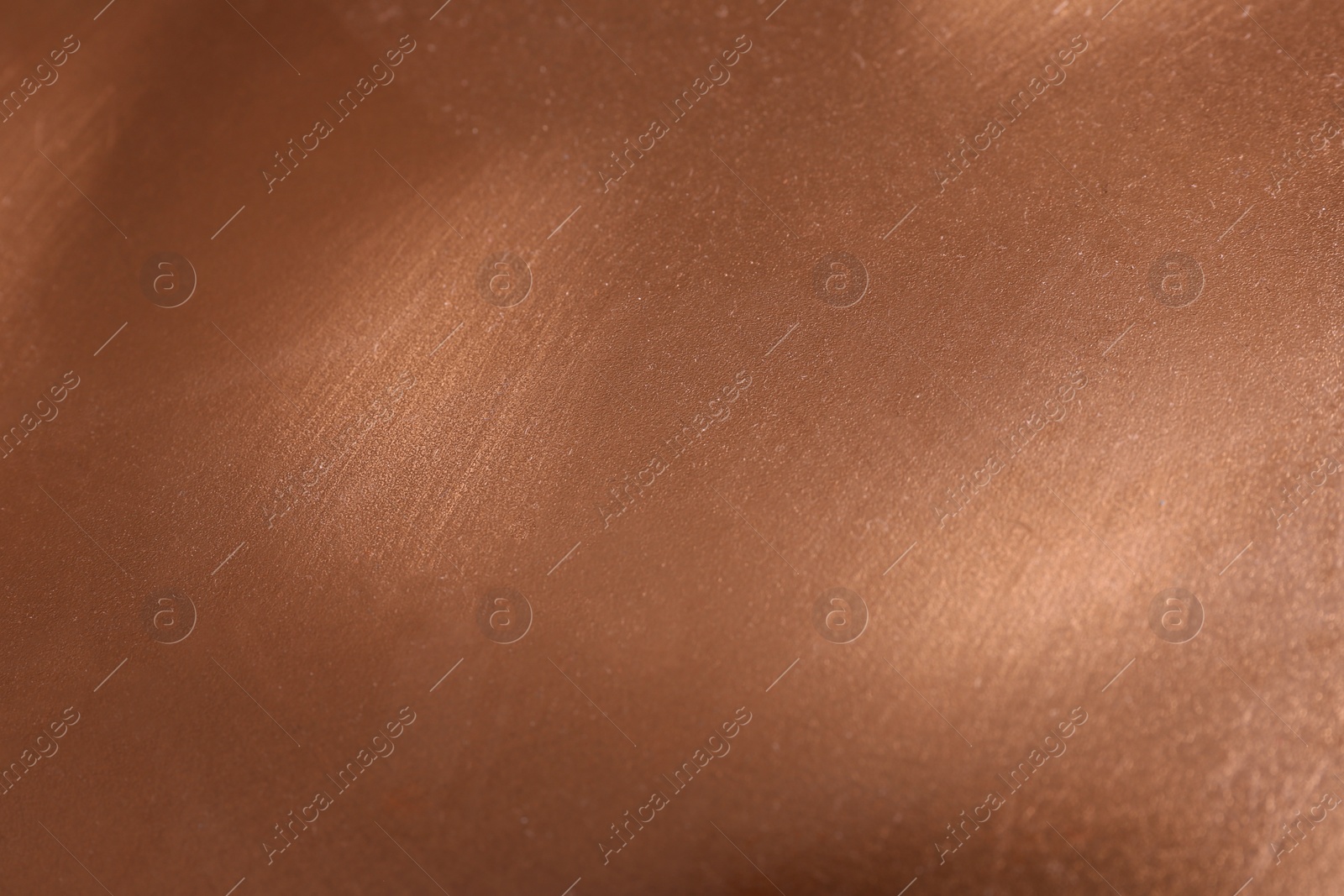 Photo of Plain rose gold surface as background, closeup