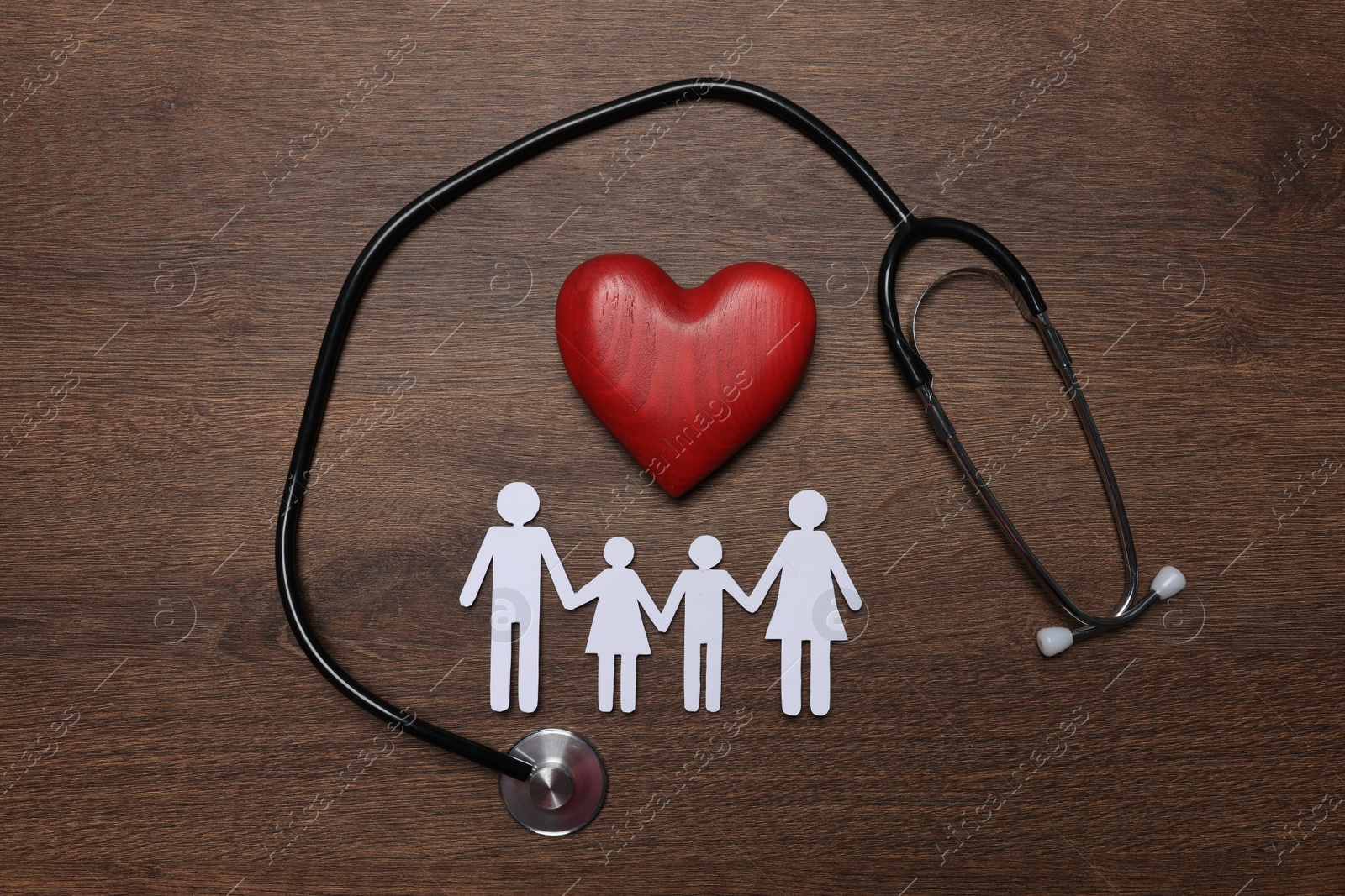 Photo of Paper family cutout, red heart and stethoscope on wooden background, flat lay. Insurance concept