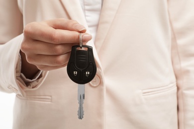 Young woman holding car key, closeup view