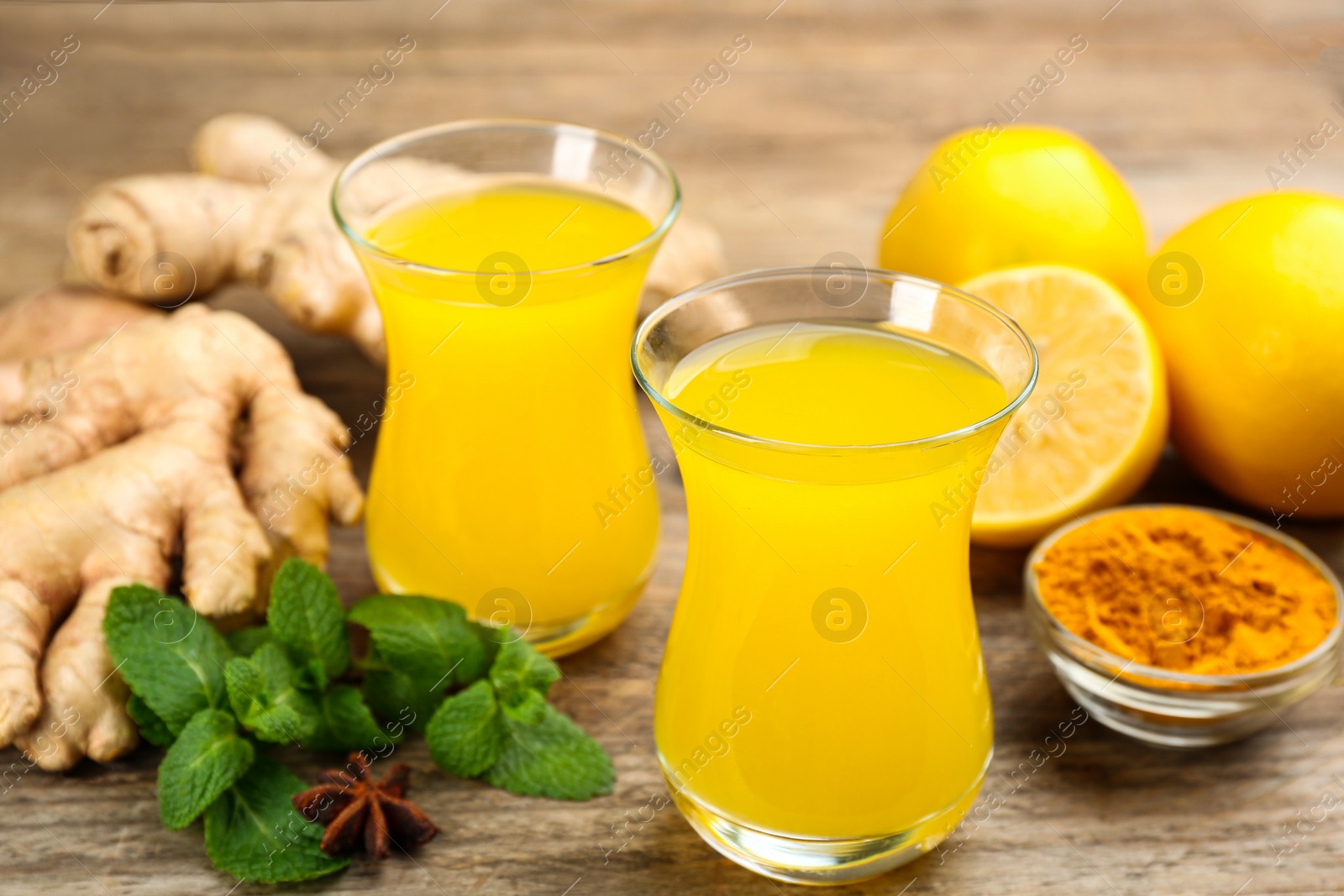 Photo of Immunity boosting drink and ingredients on wooden table